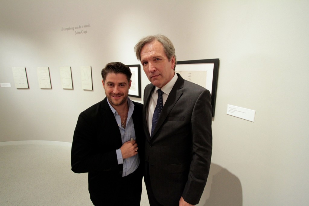 Jon Abrahams and Martin Donovan in front of the Philip Glass Exhibit at the Burchfield-Penney Art Center.